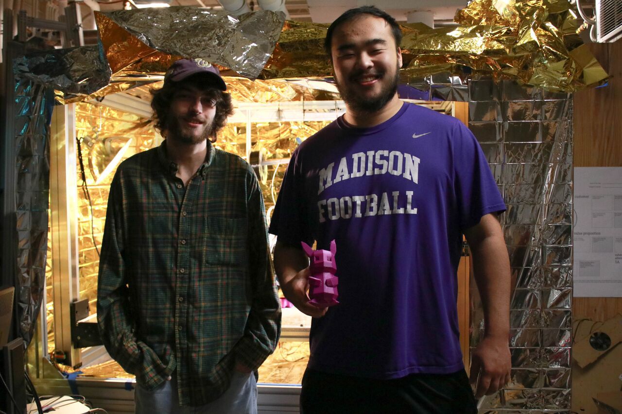 JMU student and alumnus work on 3-D printer